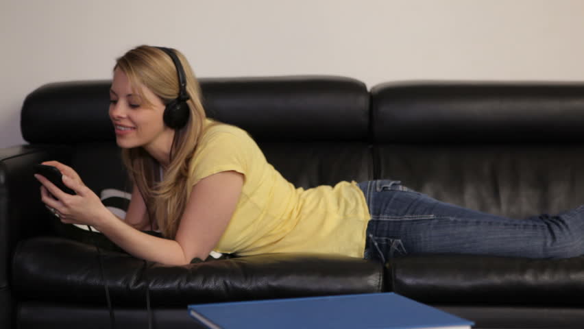 Woman Laying On Couch Listening Stock Footage Video 100