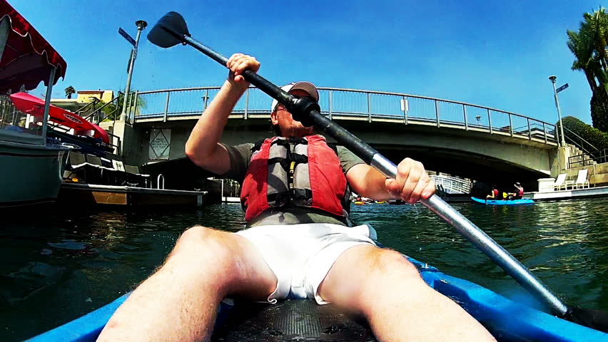 Activities Long Beach Ca Footage Stock Clips A Or Middle Aged Man Paddles Sea Kayak Is Kayaking Under Bridge Long Beach