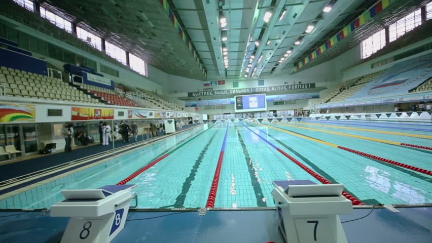 Olympic Swimming Pool 2017 montreal, canada - may 2017: smooth steadicam shot of swimming Olympic Swimming Pool 2017 montreal, canada - may 2017: smooth steadicam shot of swimming