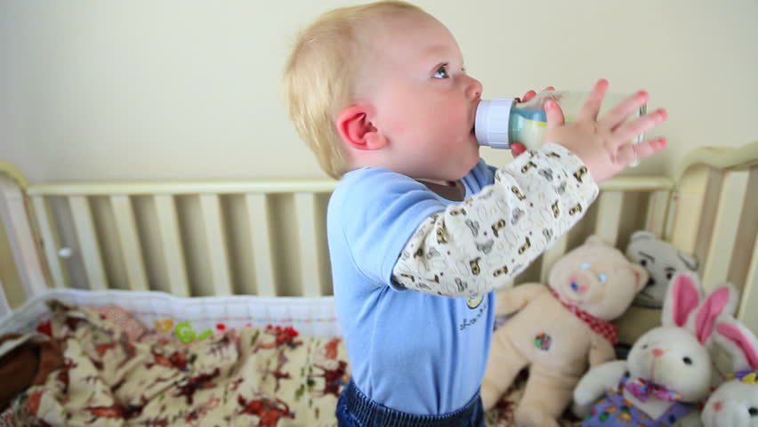 Baby Drinking His Bottle In Crib