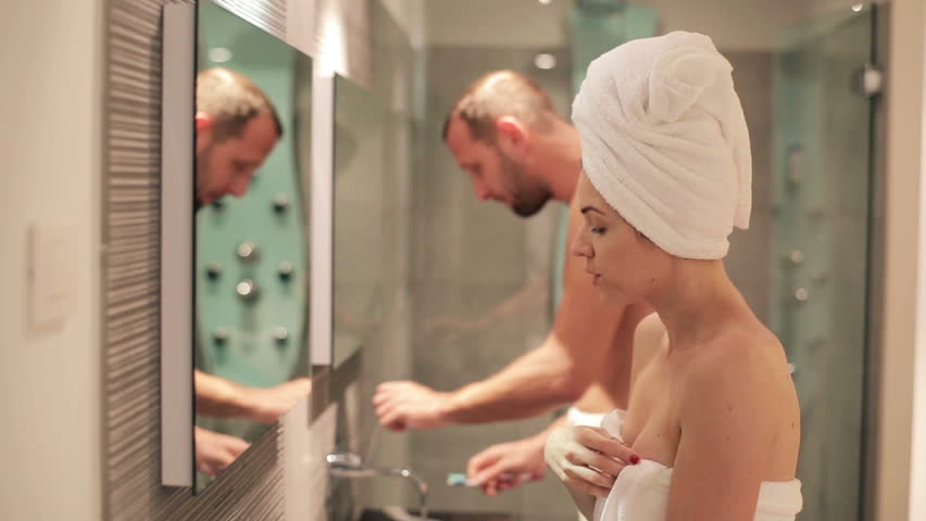 couple using washroom in front of each other