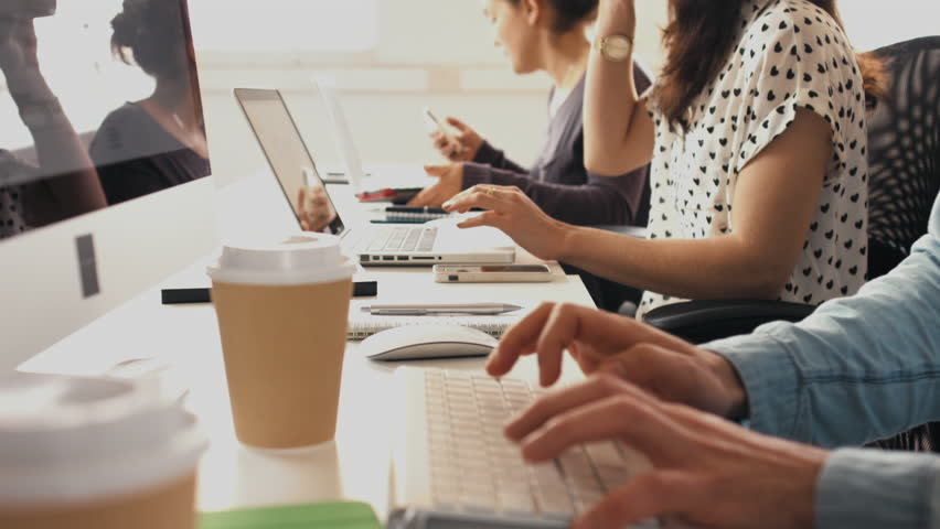 Close-up hands typing on keyboards in office business people typing