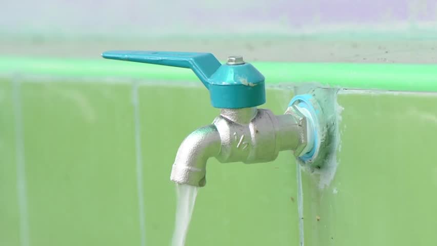 Female Hand Turn On Water At The Tap, Water Flows On And Off The Tap ...