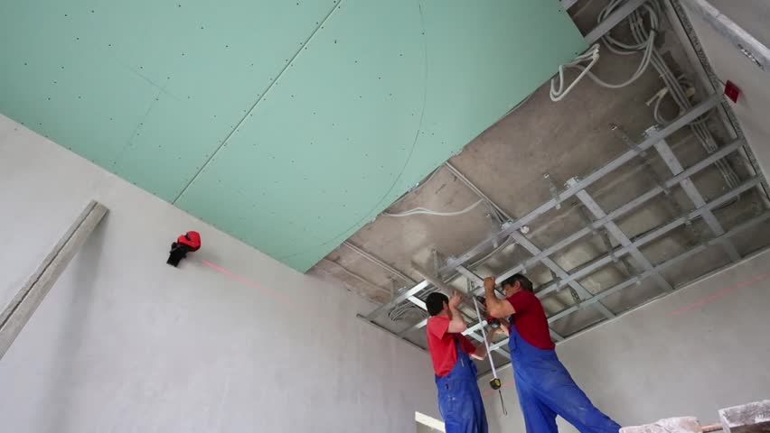 Workers Verify Accuracy Of Installation Frame For Hung Ceiling Install