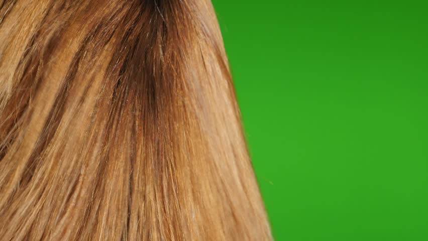 Woman tying her hair up on green screen  CanStock