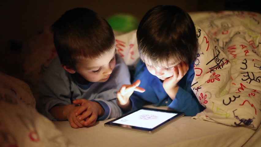Young Mother Read A Book To Her Tho Children Boys In The Living Cute Little Brothers Playing On Tablet In Bed At Night Hd Stock Video Clip